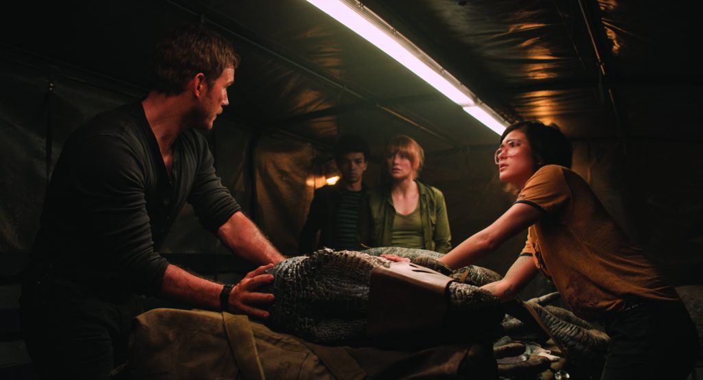 (L to R) Owen (CHRIS PRATT), Franklin (JUSTICE SMITH), Claire (BRYCE DALLAS HOWARD) and Zia (DANIELLA PINEDA) try and save Blue in "Jurassic World: Fallen Kingdom."