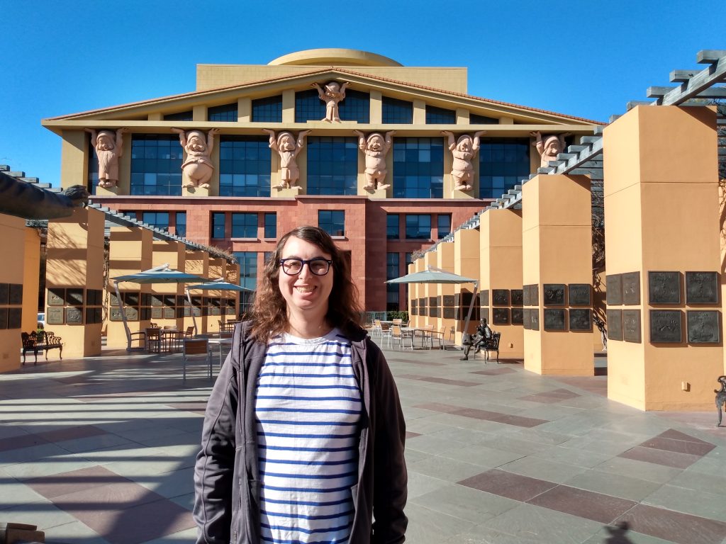 Danielle Solzman poses in front of Team Disney.