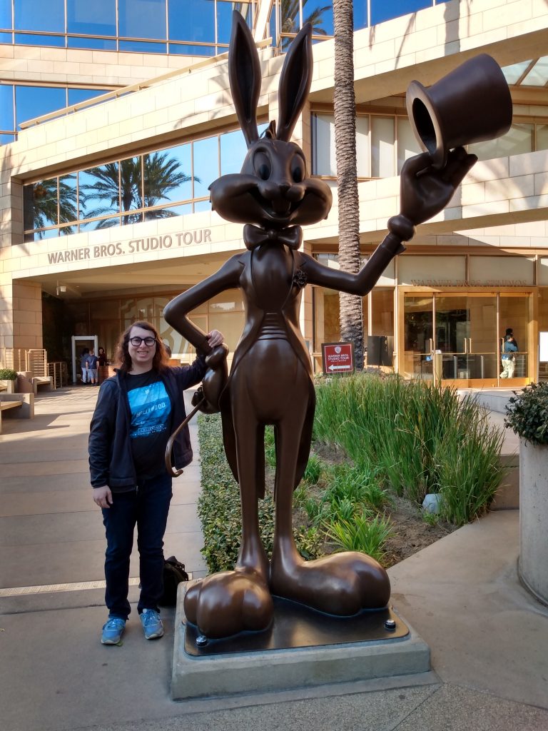 Danielle Solzman poses with Bugs Bunny in front of the Warner Brothers Studio tour entrance.