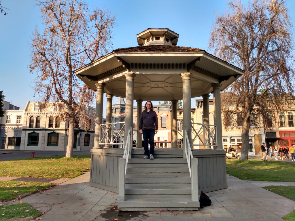 Danielle Solzman poses on a gazebo in the Warner Brothers Studios backlot.