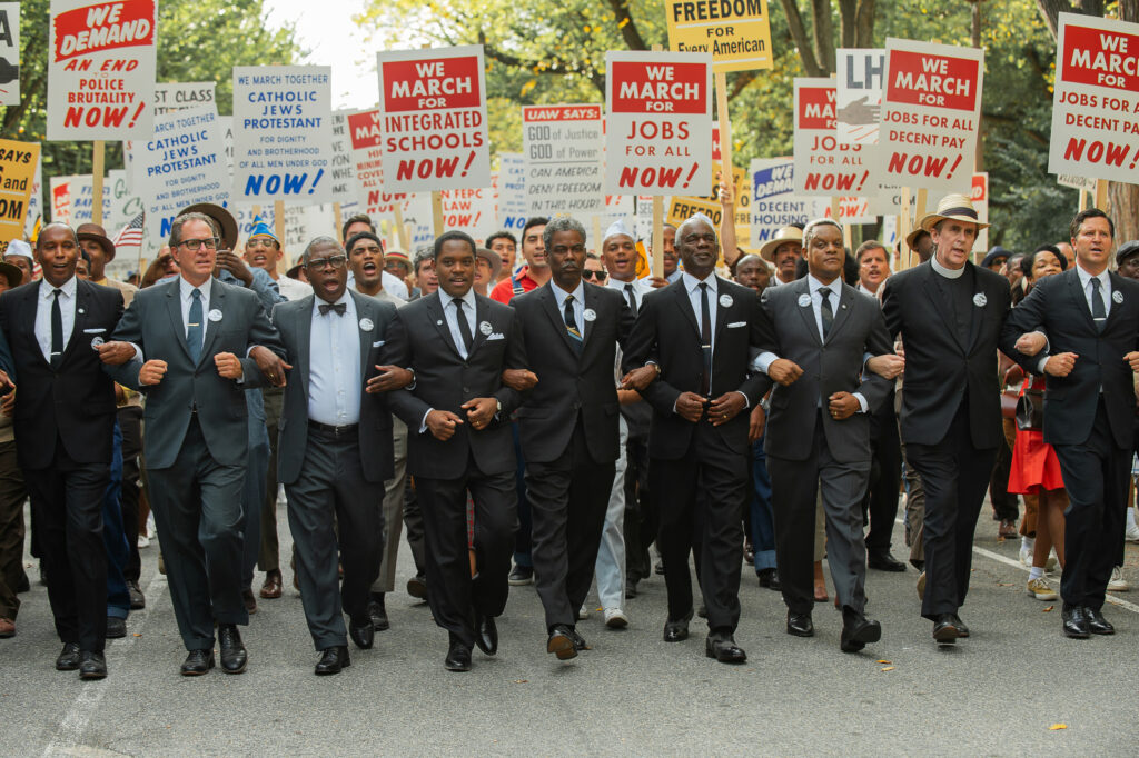 (L to R) Michael Potts as Cleve Robinson, Aml Ameen as Martin Luther King Jr., Chris Rock as NAACP Exec. Dir. Roy Wilkins, Glynn Turman as A. Philip Randolph and Kevin Mambo as Whitney Young in Rustin.