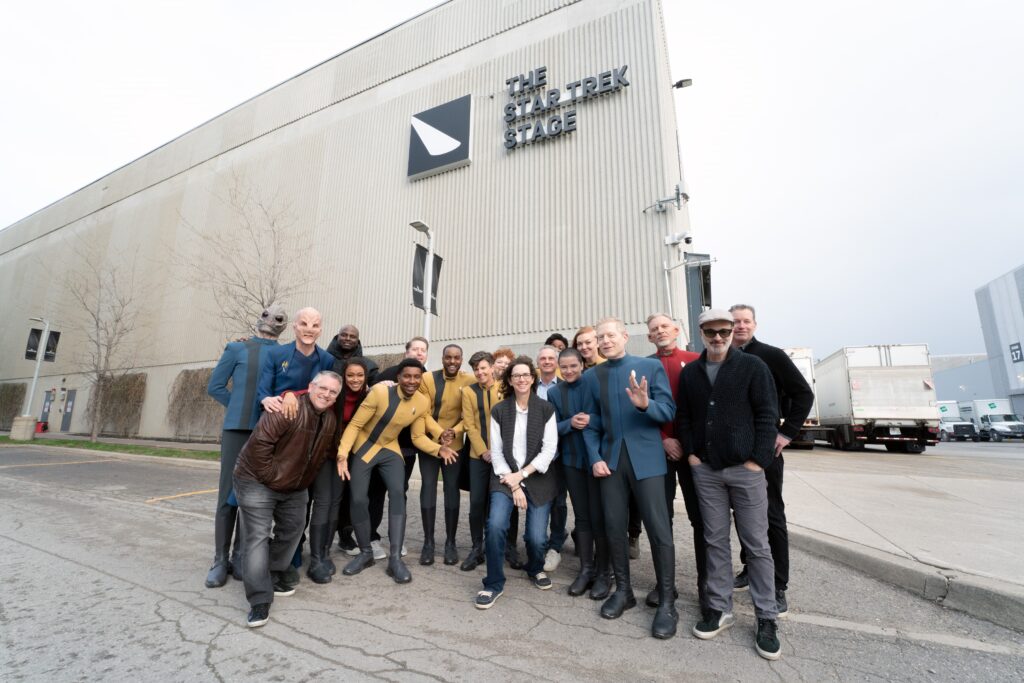 L-R: David Tomlinson, Doug Jones, Trevor Roth, Sonequa Martin-Green, Olatunde Osunsanmi, Aaron Baiers, Orville Cummings, Ronnie Rowe Jr. Tig Notaro, Mary Wiseman, Michelle Paradise, Frank Siracusa, Oyin Oladejo, Blu del Barrio, Emily Coutts, Anthony Rapp, Callum Keith Rennie, Alex Kurtzman, and John Weber at the Star Trek: Discovery season 5 stage, 2023.