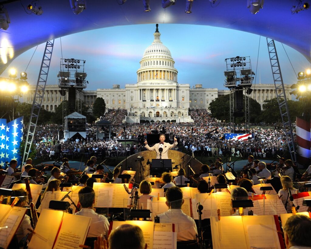 Jack Everly conducts the National Symphony Orchestra before the on-site audience on the West Lawn of the U.S. Capitol.