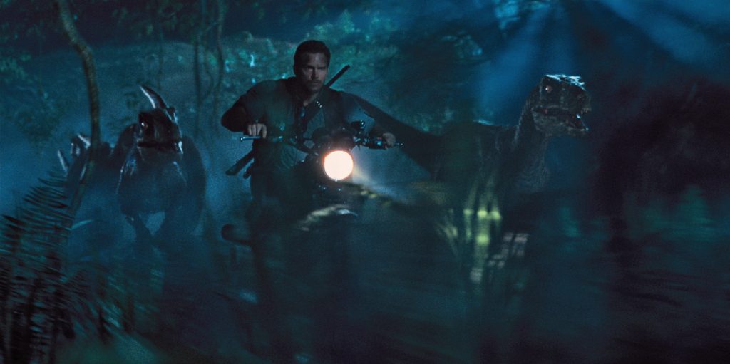 Owen (CHRIS PRATT) leads the raptors on a mission in “Jurassic World”.