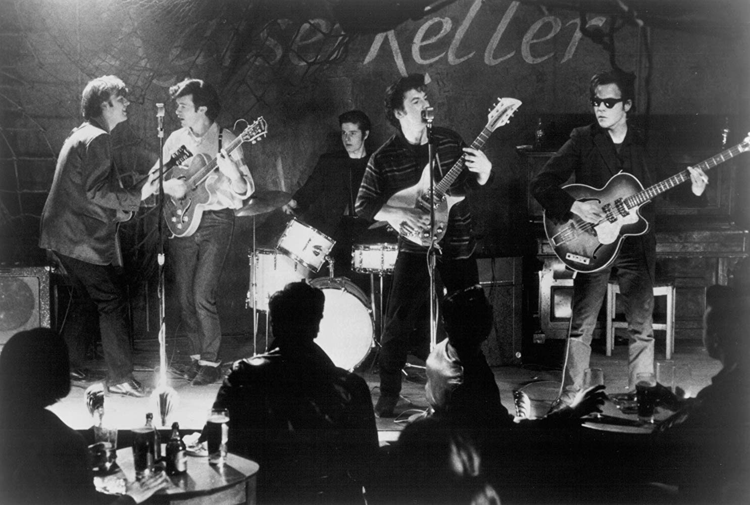 Paul McCartney (Gary Bakewell), George Harrison (Chris O'Neill), Pete Best (Scot Williams), John Lennon (Ian Hart), and Stuart Sutcliffe (Stephen Dorff) perform as The Beatles at the Kaiserkeller in Backbeat.