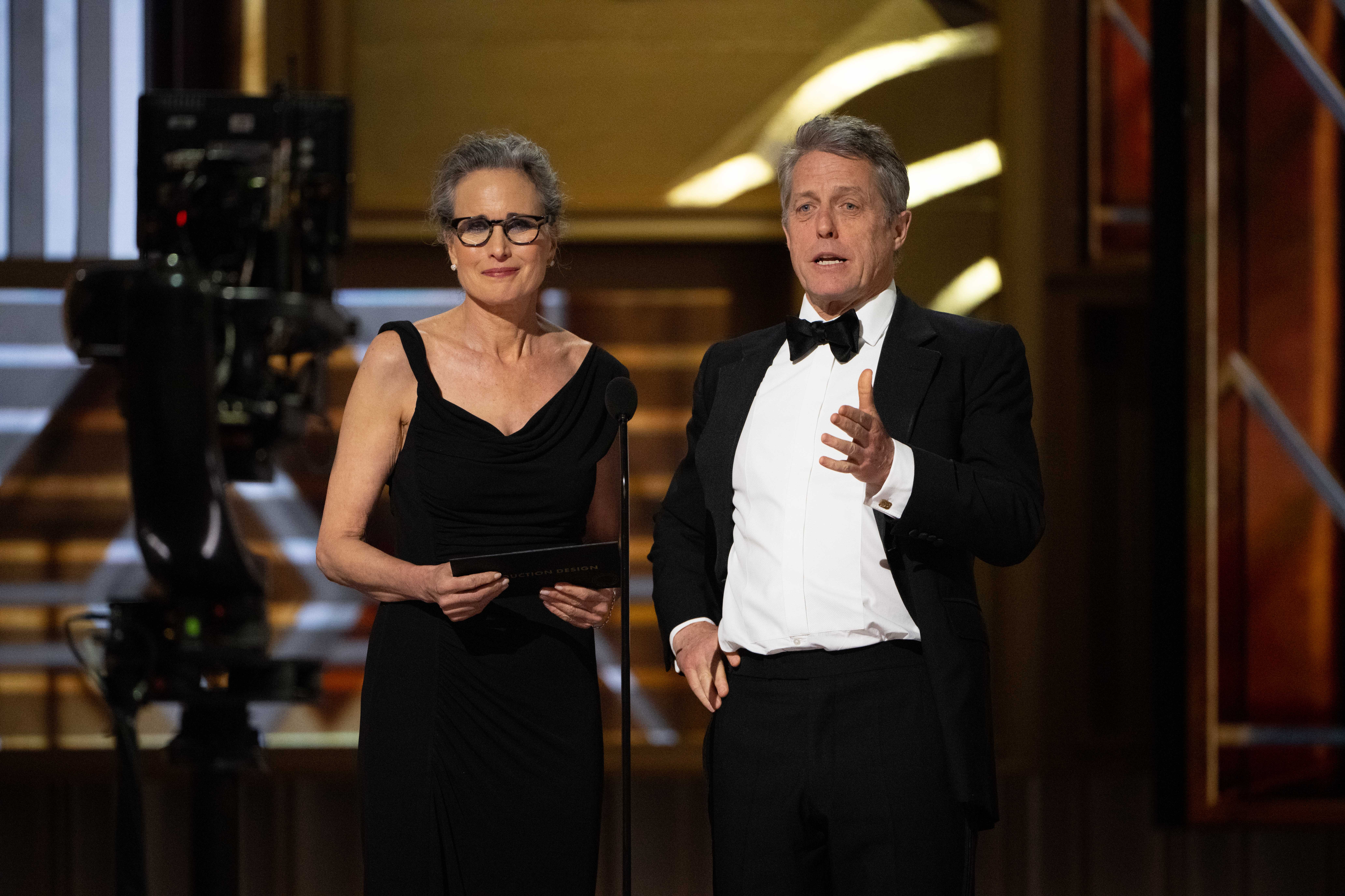 Andie MacDowell and Hugh Grant present the Oscar for Production Design during the live ABC telecast of the 95th Oscars at the Dolby Theatre at Ovation Hollywood on Sunday, March 12, 2023