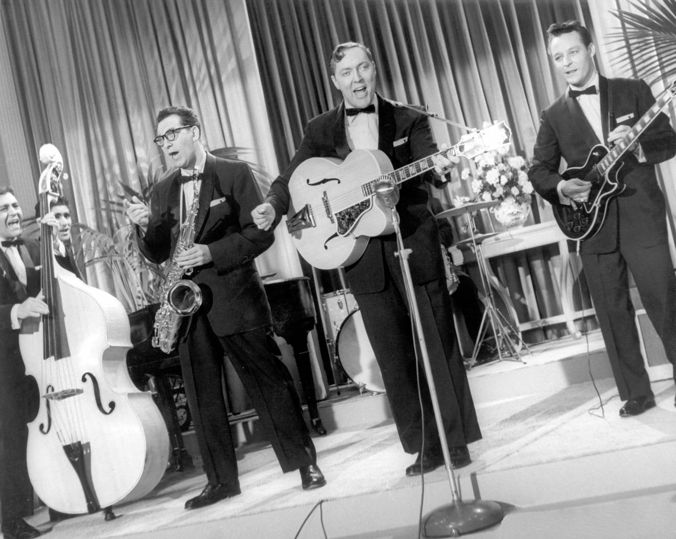 Bill Haley and His Comets (L-R: Al Rex, Johnny Grande, Rudy Pompilli, Bill Haley, and Franny Beecher) in Rock Around the Clock.