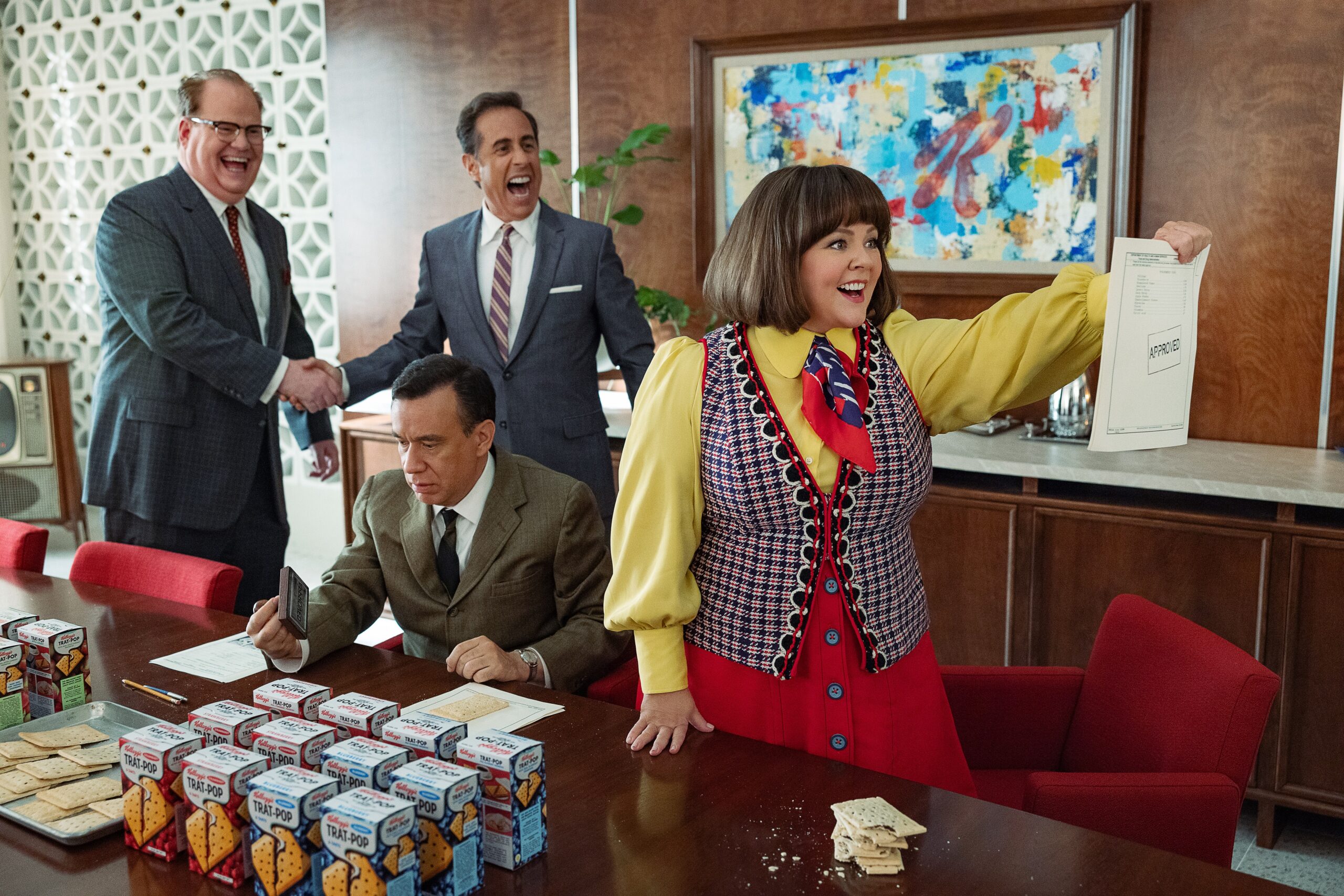 (L to R) Jim Gaffigan as Edsel Kellogg III, Jerry Seinfeld (Director) as Bob Cabana, Fred Armisen as Mike Puntz and Melissa McCarthy as Donna Stankowski in Unfrosted: The Pop-Tart Story.