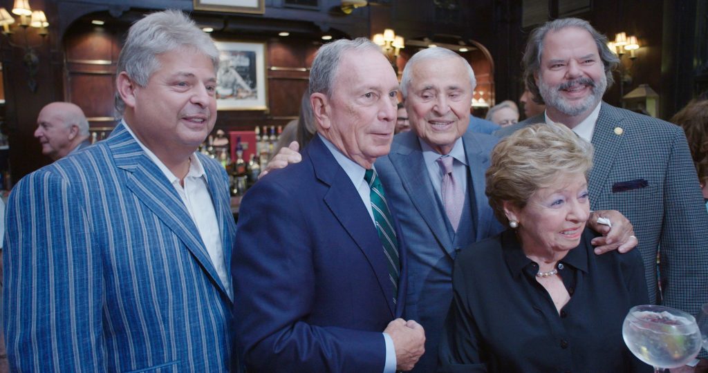 Jay Greenfield, former New York mayor Michael Bloomberg, tailor Martin Greenfield, Martin’s wife Arlene, and Martin’s son Tod at Martin’s 90th birthday party at the Friars Club, New York, New York, in a still from The Presidents' Tailor.