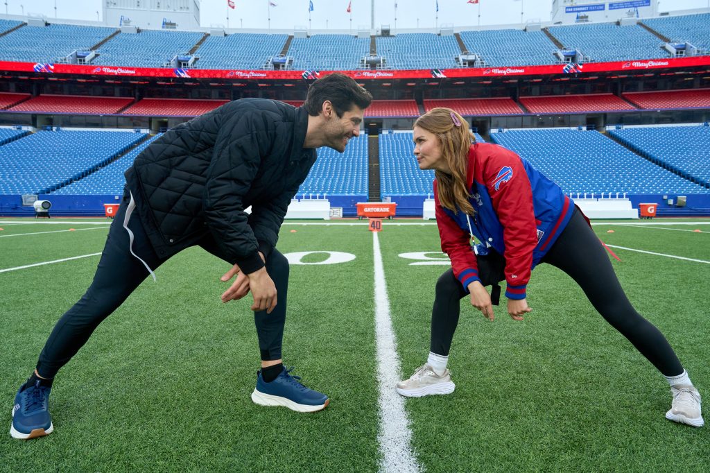 Matthew Daddario and Holland Roden in Holiday Touchdown: A Bills Love Story.