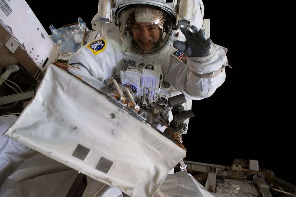 NASA astronaut Jessica Meir waves at the camera during a spacewalk with fellow NASA astronaut Christina Koch (out of frame) on October 18, 2019.
