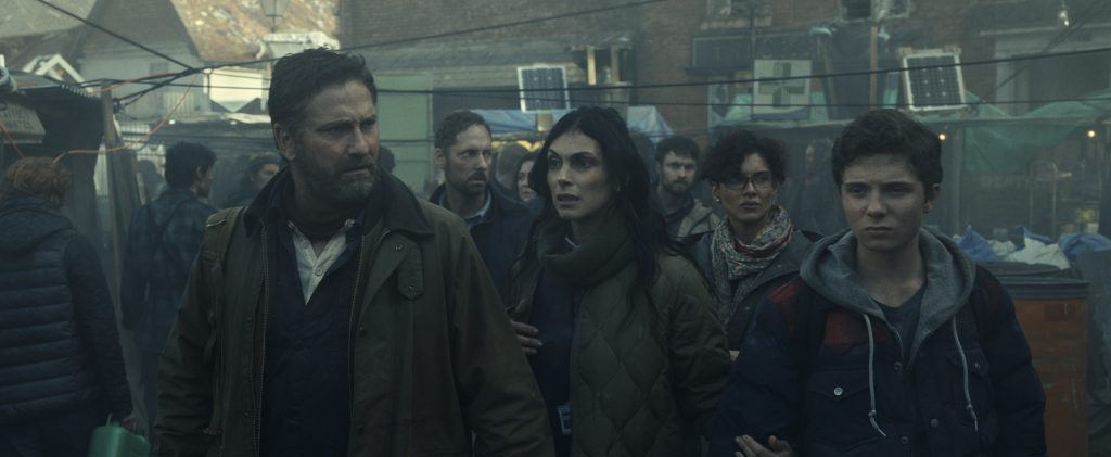 Gerard Butler as John Garrity, Morena Baccarin as Allison Garrity, Amber Rose Revah as Dr. Casey Amina, and Roman Griffin Davis as Nathan Garrity in Greenland 2: Migration.